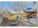 Outdoor patio with seating, fire pit, and a grill, perfect for enjoying the serene backyard setting at 3311 E Euclid Ave, Centennial, CO 80121