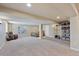 Finished basement features ample space, a cozy chair, and shelving for versatile use at 3311 E Euclid Ave, Centennial, CO 80121