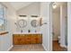 Modern bathroom with double sinks, wood cabinets, and stylish light fixtures at 3311 E Euclid Ave, Centennial, CO 80121