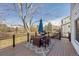 Outdoor deck features a grill, dining set, umbrella, and views of the backyard and surrounding landscape at 3311 E Euclid Ave, Centennial, CO 80121