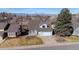 Charming home featuring a well-manicured lawn, two-car garage, and welcoming entryway, set against a backdrop of distant mountains at 3311 E Euclid Ave, Centennial, CO 80121