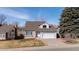 Two-story home featuring gray siding, brick accents, a well-maintained lawn, and an attached garage at 3311 E Euclid Ave, Centennial, CO 80121