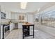 Bright and airy kitchen featuring white cabinetry, stainless steel appliances, and a large window with natural light at 3311 E Euclid Ave, Centennial, CO 80121