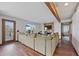 Cozy living room featuring hardwood floors, exposed beams, a stone fireplace, and large windows with natural light at 3311 E Euclid Ave, Centennial, CO 80121