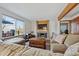 Comfortable living room featuring a fireplace, large windows, and a plush sofa with plenty of seating at 3311 E Euclid Ave, Centennial, CO 80121