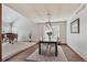 Open-concept living and dining area featuring hardwood floors, a neutral color palette, and plenty of natural light at 3311 E Euclid Ave, Centennial, CO 80121