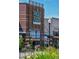 Exterior of Whole Foods Market with brick facade, clear signage, and lush floral displays at the entrance at 3311 E Euclid Ave, Centennial, CO 80121