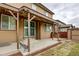 Covered patio, outdoor seating, and private backyard with wood fence at 25046 E Bayaud Pl, Aurora, CO 80018