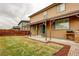 Inviting backyard with covered patio, lawn, and wood fence at 25046 E Bayaud Pl, Aurora, CO 80018