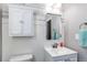 Bathroom with white vanity, mirror, storage cabinet, and decorative accents at 25046 E Bayaud Pl, Aurora, CO 80018