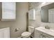 Charming powder room featuring a white vanity, toilet, and decorative wall paneling at 25046 E Bayaud Pl, Aurora, CO 80018