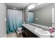 Bathroom featuring a vanity with single sink, and bathtub shower combination with blue curtain at 25046 E Bayaud Pl, Aurora, CO 80018