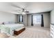 Spacious bedroom with ceiling fan, two windows, and neutral carpet at 25046 E Bayaud Pl, Aurora, CO 80018