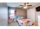 Bright bedroom with modern ceiling fan, closet, and a colorful soccer themed bed and curtains at 25046 E Bayaud Pl, Aurora, CO 80018
