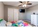 Bedroom featuring a modern ceiling fan, mounted flat screen tv, and closet for storage at 25046 E Bayaud Pl, Aurora, CO 80018