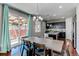Bright dining room with a rustic table, chandelier, and sliding glass doors to the backyard patio at 25046 E Bayaud Pl, Aurora, CO 80018