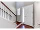 Foyer area with staircase featuring white railings and a front door with glass panel insert at 25046 E Bayaud Pl, Aurora, CO 80018