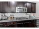 Well-equipped kitchen with modern appliances, granite countertops, a gas range, and ample cabinet space at 25046 E Bayaud Pl, Aurora, CO 80018