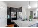 Modern kitchen with stainless steel appliances, granite countertops, and dark wood cabinetry at 25046 E Bayaud Pl, Aurora, CO 80018