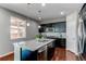 Modern kitchen with a large island, stainless steel appliances, and sleek cabinetry with hardwood floors at 25046 E Bayaud Pl, Aurora, CO 80018