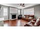 Comfortable living room with hardwood floors, a fireplace, and leather seating, perfect for relaxation at 25046 E Bayaud Pl, Aurora, CO 80018