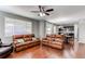Open-concept living area showcasing hardwood floors, a ceiling fan, and seamless flow to the kitchen and dining space at 25046 E Bayaud Pl, Aurora, CO 80018