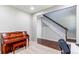Home office with piano, view into the house showing stairs with dark wood and white railing at 25046 E Bayaud Pl, Aurora, CO 80018
