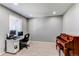 Home office setup with two monitors, a desk, a chair, and a piano in a carpeted room at 25046 E Bayaud Pl, Aurora, CO 80018