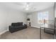 Spacious bedroom with a cozy couch and built-in shelving at 1705 Peridot Ct, Castle Rock, CO 80108