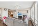 Open-concept Gathering room with sectional sofa and hardwood floors at 1705 Peridot Ct, Castle Rock, CO 80108