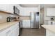 Bright kitchen featuring stainless steel appliances and white cabinetry at 1705 Peridot Ct, Castle Rock, CO 80108