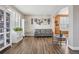 Bright living room featuring hardwood floors and built-in shelving at 1705 Peridot Ct, Castle Rock, CO 80108