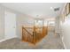 Upstairs hallway with carpeted flooring and wooden railing at 1705 Peridot Ct, Castle Rock, CO 80108