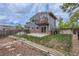 The fenced backyard with mature trees, garden beds, and patio offers a serene and private outdoor space at 12682 Fairfax St, Thornton, CO 80241