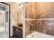 An updated bathroom featuring a vessel sink, decorative tile, and modern fixtures create a spa-like retreat at 12682 Fairfax St, Thornton, CO 80241