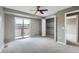 Spacious primary bedroom with sliding glass door to private balcony and large closet provides a luxurious retreat at 12682 Fairfax St, Thornton, CO 80241