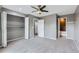 Spacious bedroom with gray carpet, a ceiling fan, closet and doorways leading to a bath and storage at 12682 Fairfax St, Thornton, CO 80241