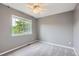Bright bedroom featuring neutral walls, a large window, carpet and a ceiling fan at 12682 Fairfax St, Thornton, CO 80241