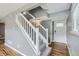 Inviting entryway with hardwood floors, stairs with white railing, and a front door with decorative glass at 12682 Fairfax St, Thornton, CO 80241
