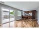 Open-concept kitchen featuring stainless steel appliances, breakfast bar, and sliding doors to the patio at 12682 Fairfax St, Thornton, CO 80241