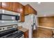 Close up of the updated kitchen features stainless steel appliances and granite countertops at 12682 Fairfax St, Thornton, CO 80241