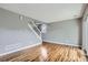 Bright, open living room featuring hardwood floors, large windows, and staircase access at 12682 Fairfax St, Thornton, CO 80241