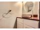 Stylish powder room featuring a modern vessel sink, granite countertop, and elegant fixtures at 12682 Fairfax St, Thornton, CO 80241
