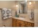 Well-lit bathroom featuring a stylish vanity with granite countertops and decorative towels at 947 Dogwood Dr, Golden, CO 80401