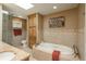 Inviting bathroom with a soaking tub, separate shower, and stylish tile work at 947 Dogwood Dr, Golden, CO 80401