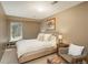 Cozy bedroom featuring a large window, cushioned chair, decorative pillows and neutral tones at 947 Dogwood Dr, Golden, CO 80401