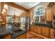Kitchen island with a sink next to the dining area with stainless steel refrigerator at 947 Dogwood Dr, Golden, CO 80401