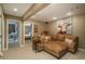 Comfortable basement living room with plush seating, a cow painting, and ample space for relaxation at 947 Dogwood Dr, Golden, CO 80401