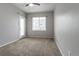 Spacious bedroom with carpet flooring, a ceiling fan, and access to the outside patio at 4451 S Ammons St # 2-204, Littleton, CO 80123
