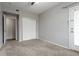 Carpeted bedroom with closet, access to patio, neutral walls, and ceiling fan at 4451 S Ammons St # 2-204, Littleton, CO 80123